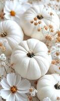 A white pumpkin sits on a table with flowers. The pumpkin is the main focus of the image, and the flowers are arranged around it. Scene is warm and inviting, with the pumpkin photo
