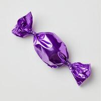 A clean and glossy purple candy wrapper beautifully showcases a delicious sweet treat hidden inside. The design is kept simple, enhancing the foil texture and the appealing, vibrant color photo