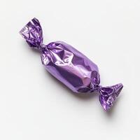 A vibrant purple candy wrapped in shiny foil stands out against a white background. This delightful treat is perfect for festive displays, appealing to all ages and adding fun to any celebration photo