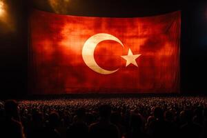 A large Turkish flag, with its vivid red background and white star, is proudly showcased during a celebration symbolizing national pride, unity, and the cultural heritage of the Turkish people photo