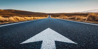 A straight asphalt road ahead, marked by an arrow, symbolizes progress and a promising future filled with opportunities for those brave enough to embrace the unknown and new experiences photo