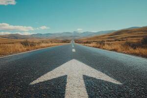 An expansive asphalt road stretches out beneath a vast blue sky, symbolizing both the journey of life we all embark on and the promising progress that lies ahead for each one of us photo