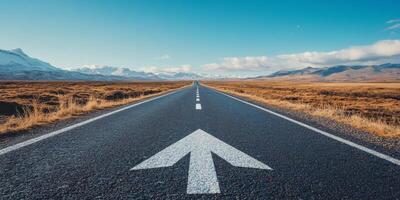 An asphalt road with a forward arrow symbolizes progress and diverse travel experiences, set under a bright blue sky with a few clouds, representing a clear path to future achievements photo