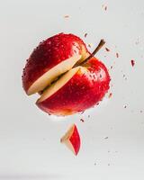 An apple is being cut in half by a knife photo