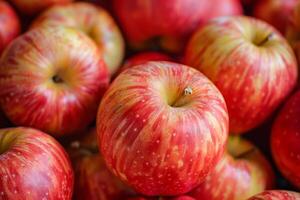 A close up of a bunch of red and yellow apples photo