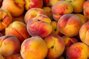 Peaches are piled up in a pile photo