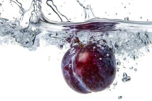 A purple plum is being splashed in water photo