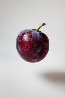Black Amber Plum Isolated With White Background photo