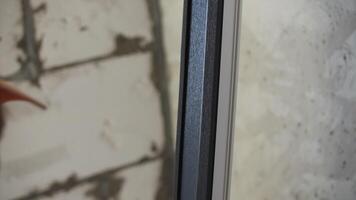 Master attaches the insulation to the window frame video
