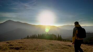 A man travels in the mountains. Beautiful nature of the Carpathian mountains. The concept of travel and active lifestyle. 4K video