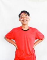 Portrait of asian man isolated on white background. Male model laughing happily in celebration studio photo shoot for Indonesian independence day.