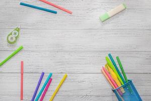 School creative flatley. Multicolored felt-tip pens with empty space for text lie on a wooden white table. photo