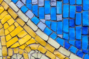 texture of multi-colored stones. Background from vintage mosaic on the wall. photo
