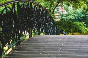 decorative bridge in the park with metal railing patterns photo
