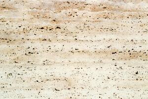 the texture of natural stone in a beige shade is similar to marble photo