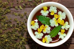 A beautiful white cup with a gold border decorated with flowers, herbal green healthy tea. Business account design photo