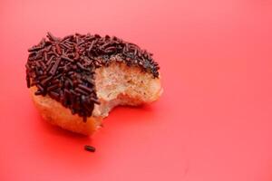bite marks on donuts with chocolate sprinkles photo