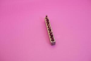 a set of screwdriver bits isolated on purple background photo