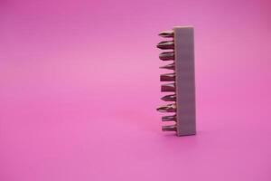 a set of screwdriver bits isolated on purple background photo