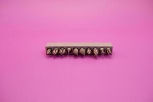 a set of screwdriver bits isolated on purple background photo