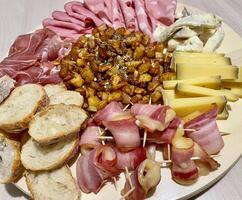 Appetizer platter with cheese and pork cold cuts photo