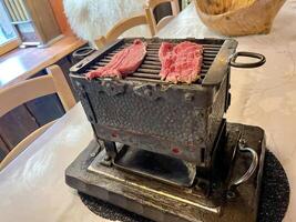 Brasero Grill with beef in an old rustic restaurant photo