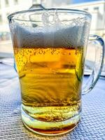 Tasty fresh draft beer in a summer day photo