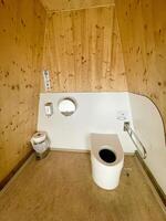 Inside of a modern wooden public toilet photo