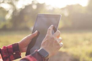 Farmers are using tablets to record data on their farm. Solar farm, smart farm, data collection photo