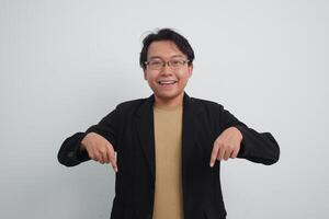 Joyful asian businessman with suit and casual shirt showing product or pointing gesture in isolated white background photo
