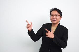 Joyful asian businessman with suit and casual shirt showing product or pointing gesture in isolated white background photo