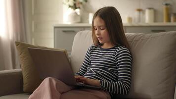 Little girl child using laptop computer kid schoolgirl student learning technology gadget typing studying education networking browsing scrolling connected pupil development electronic internet home video