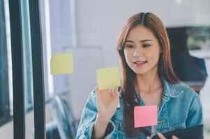 Web designers creating planning and analyzing with Colorful sticky notes on the office board.web design concept photo