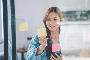 Web designers creating planning and analyzing with Colorful sticky notes on the office board.web design concept photo