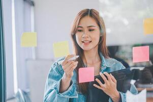 Web designers creating planning and analyzing with Colorful sticky notes on the office board.web design concept photo