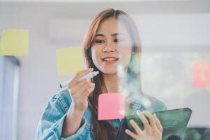 Web designers creating planning and analyzing with Colorful sticky notes on the office board.web design concept photo