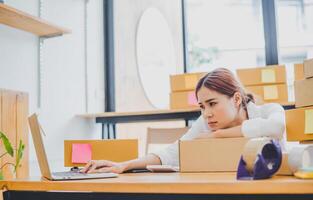 Online small business owners are sad and bored waiting for orders that haven't yet arrived. Online Retailers - Online Shopping photo