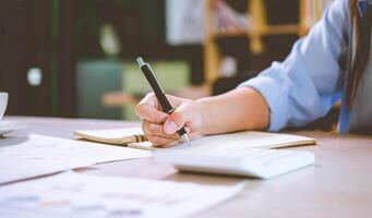 businessman pointing with pen on business report chart are working on accounts in business analysis with graphs and documentation. photo