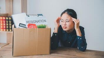 Female company employee stressed and fed up after quitting her job to look for a new job, fired or was fired by the employer photo