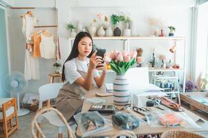 Small business owners are taking pictures of products to send to customers who will shop and take orders that customers order from an online retailer - online shopping. photo