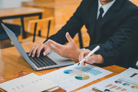group of business people working and communicating together in the office With the charging of graphs for analysis, conceptual analysis and business planning photo