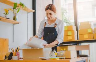 Online small business owners are packing their ordered products into the boxes for their customers based on the concept of online shopping - online shopping. photo