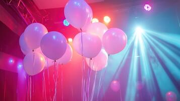 White balloons illuminated by lights photo