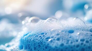 Isolated soap foam, bubbles, and blue sponge photo