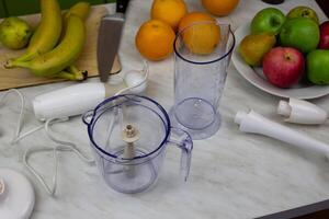 Blender containers next to fruits on table to create healthy sports drink. Items for making fruit juice in blender for healthy lifestyle photo