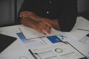 Close up of Business team analyzing income charts and graphs with modern laptop computer. Business analysis and strategy concept. photo
