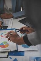 Close up of Business team analyzing income charts and graphs with modern laptop computer. Business analysis and strategy concept. photo