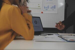 Close up of Business team analyzing income charts and graphs with modern laptop computer. Business analysis and strategy concept. photo