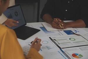 Close up of Business team analyzing income charts and graphs with modern laptop computer. Business analysis and strategy concept. photo