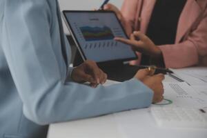 Close up of Business team analyzing income charts and graphs with modern laptop computer. Business analysis and strategy concept. photo